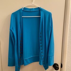 Medium blue cardigan with buttons.